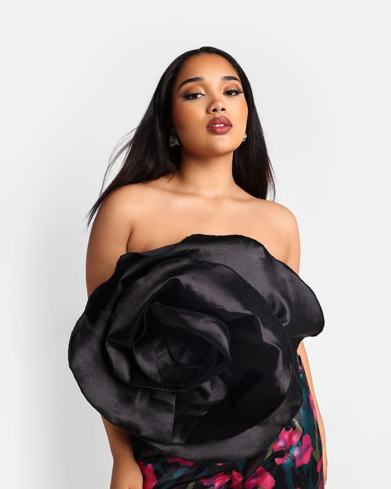 Side of a model wearing a size 4x Rebdolls Women's Dahlia Satin Dramatic Flower Corset Top in Black by Rebdolls. | dia_product_style_image_id:327826